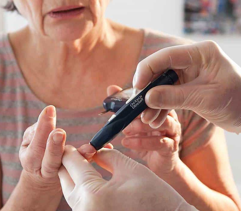 Diabetes education - woman testing blood sugar